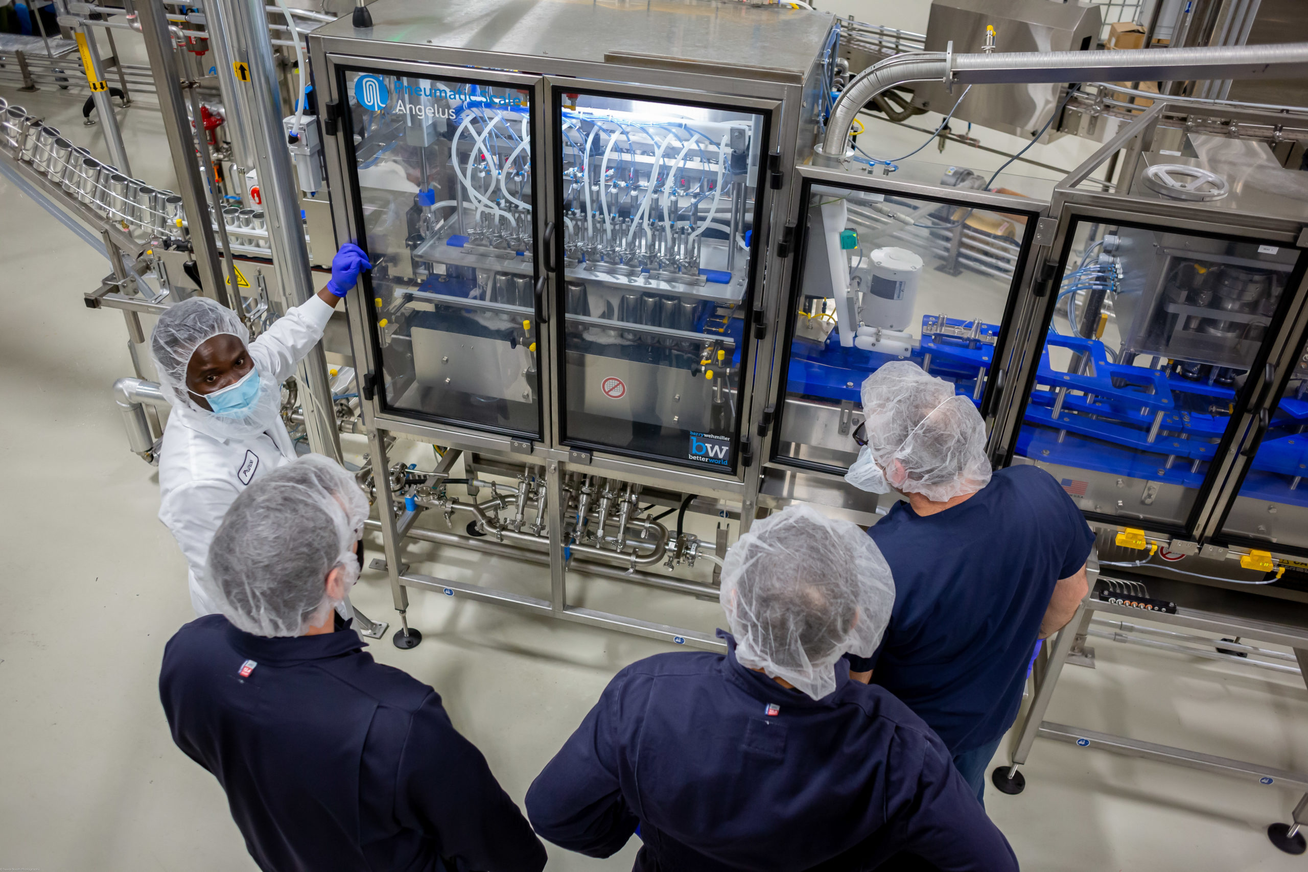 Peak team members reviewing the beverage production line